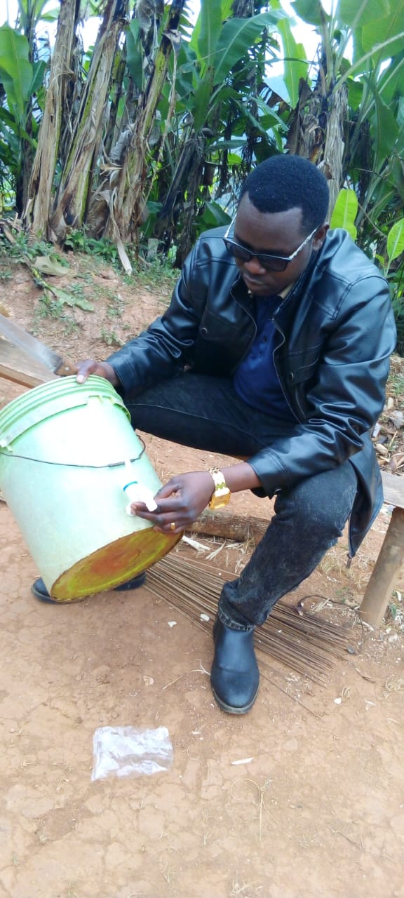 Community member fitting a tap to a water container