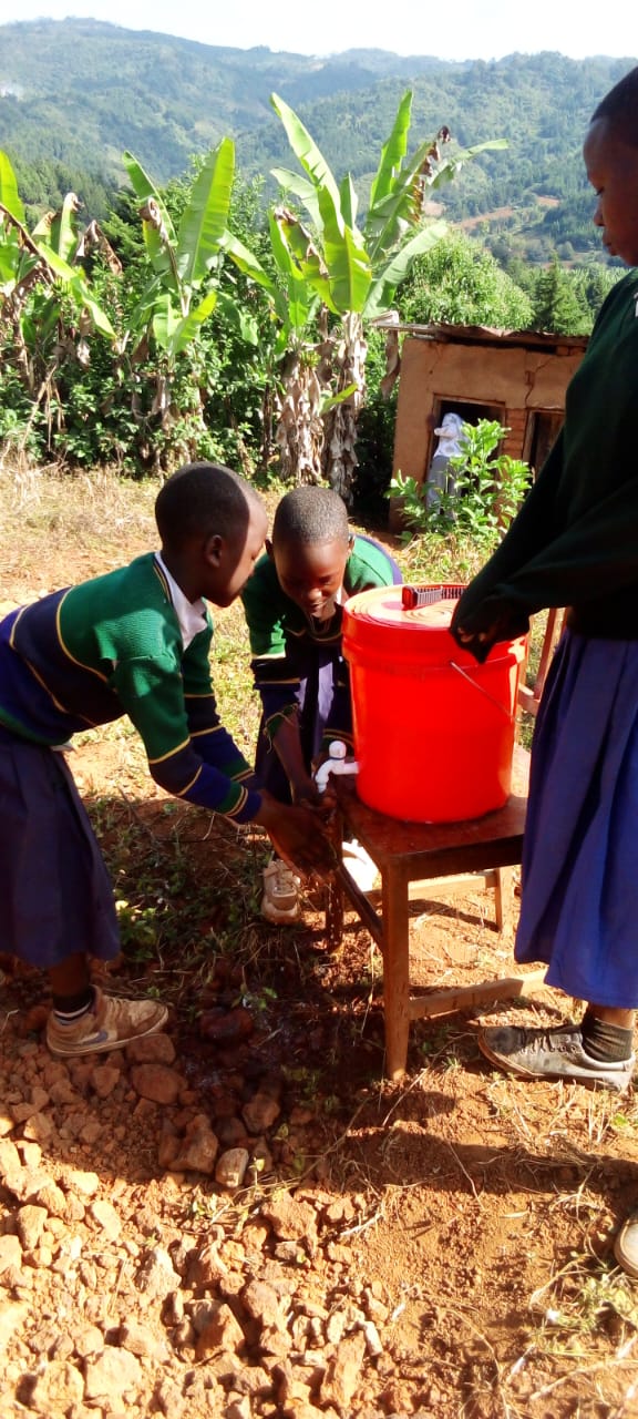 School children washing their hands at a water station